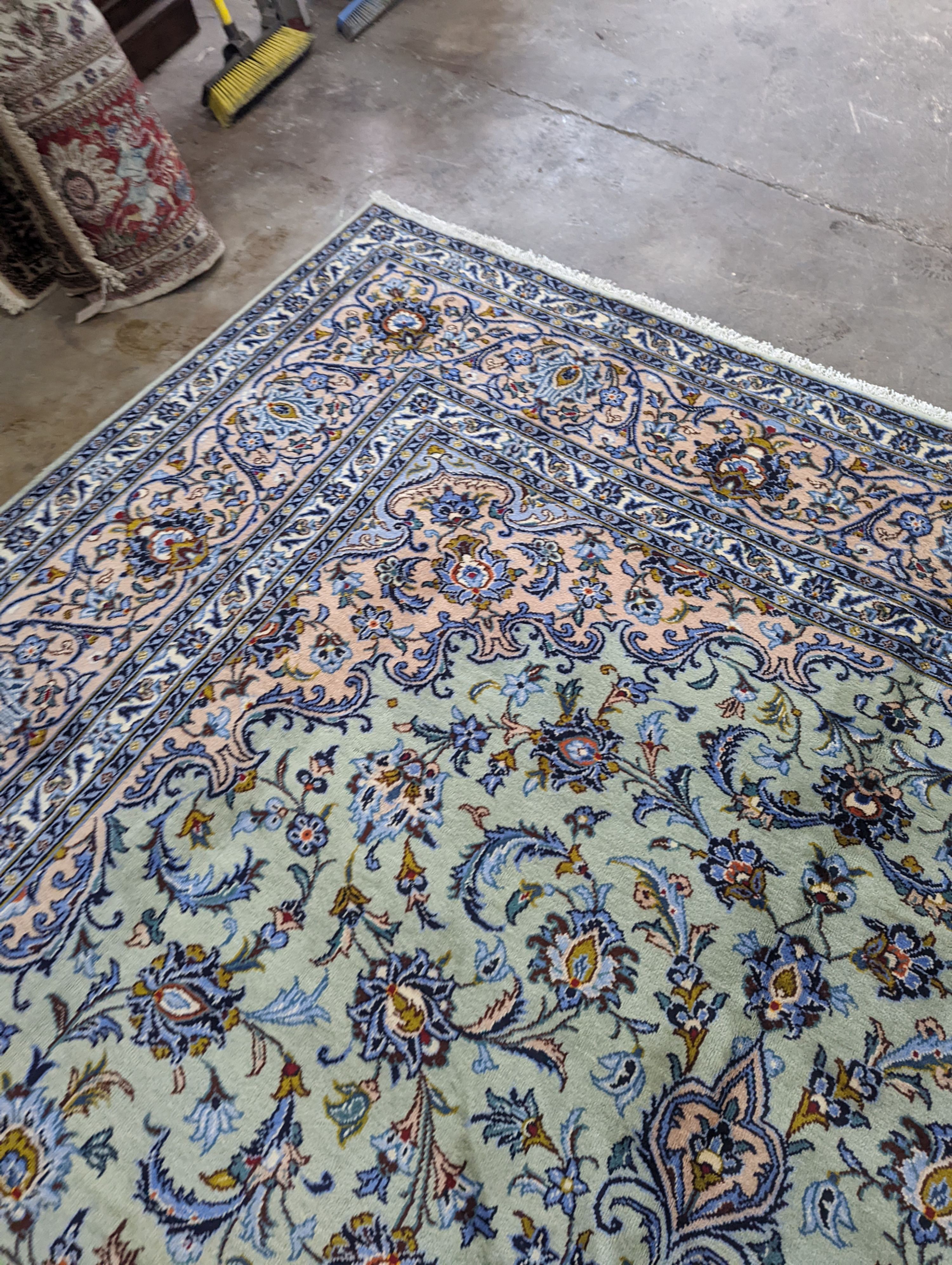 A Kashan pale green ground carpet, 410 x 296cm